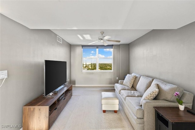 living area with light tile patterned floors, visible vents, baseboards, and ceiling fan