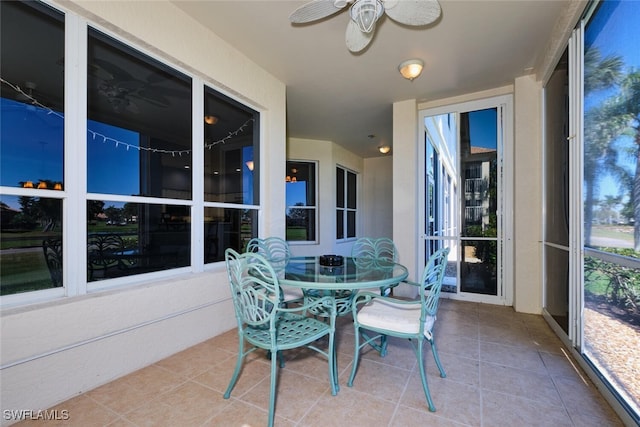 sunroom / solarium featuring a ceiling fan