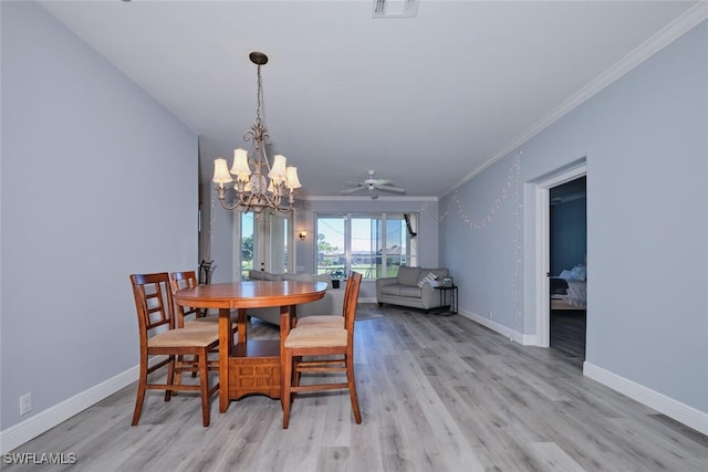 dining space featuring light wood finished floors, baseboards, and crown molding