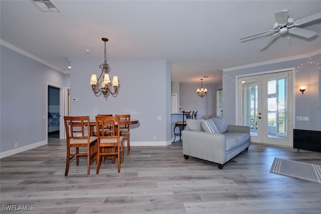 dining space with visible vents, wood finished floors, and ornamental molding