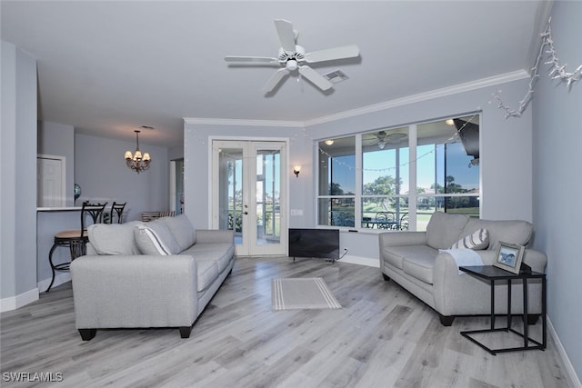 living room with ceiling fan with notable chandelier, wood finished floors, baseboards, ornamental molding, and french doors