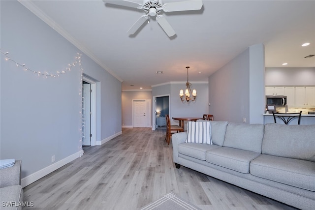 living room with recessed lighting, ceiling fan with notable chandelier, baseboards, light wood-type flooring, and crown molding