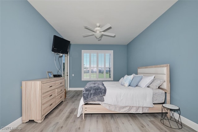 bedroom with a ceiling fan, light wood-style flooring, and baseboards