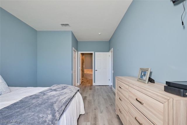 bedroom with visible vents and light wood-style floors