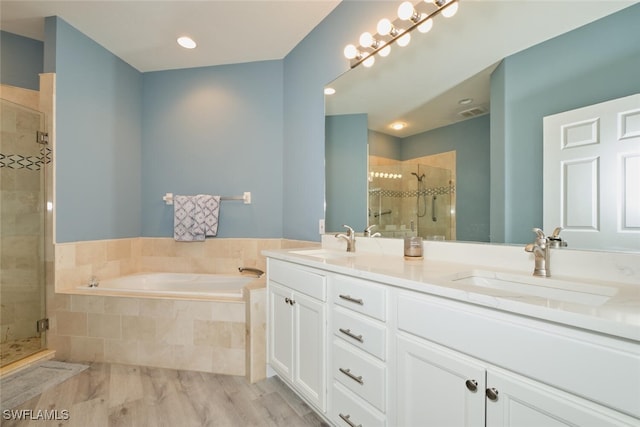 full bathroom featuring a garden tub, a sink, a shower stall, and double vanity