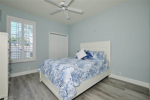 bedroom featuring a closet, baseboards, and wood finished floors