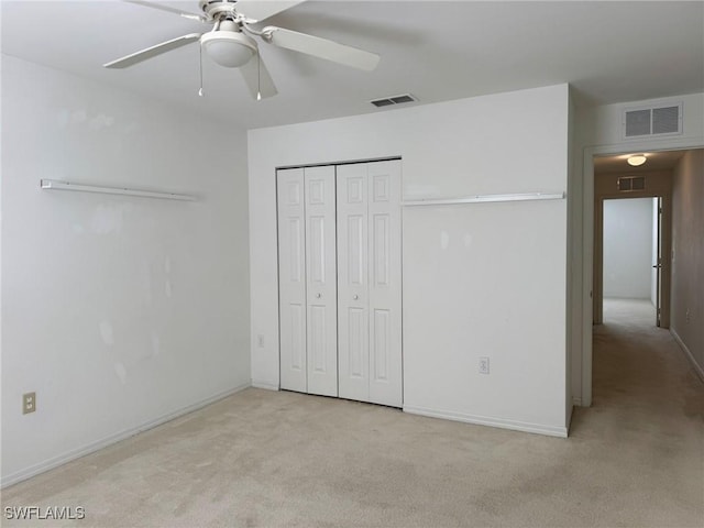 unfurnished bedroom with baseboards, carpet, visible vents, and a closet