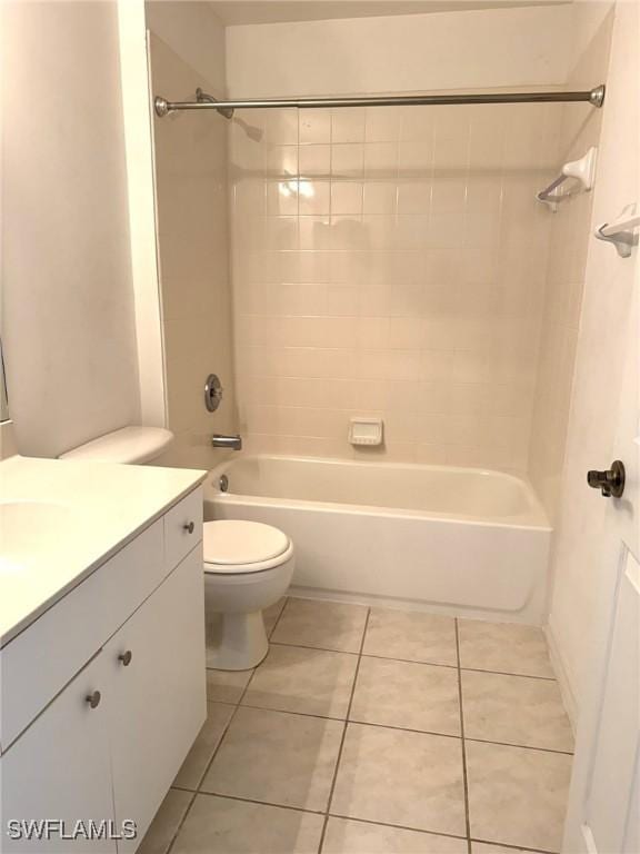 bathroom featuring toilet, shower / bathtub combination, vanity, and tile patterned floors