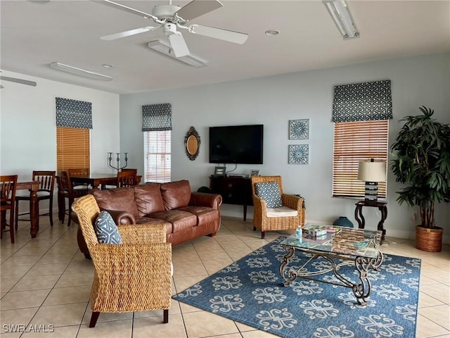 living area featuring a ceiling fan and light tile patterned flooring