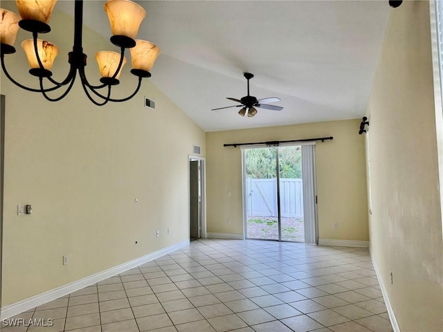 empty room featuring lofted ceiling, visible vents, baseboards, and light tile patterned floors