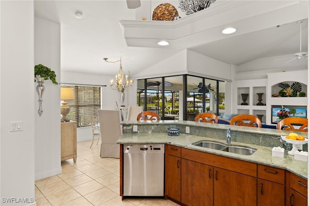 kitchen featuring light tile patterned flooring, vaulted ceiling, a sink, dishwasher, and ceiling fan with notable chandelier