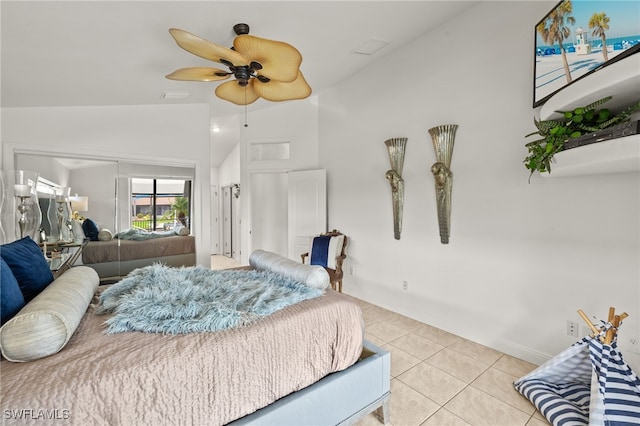 bedroom featuring light tile patterned floors, visible vents, vaulted ceiling, and a ceiling fan