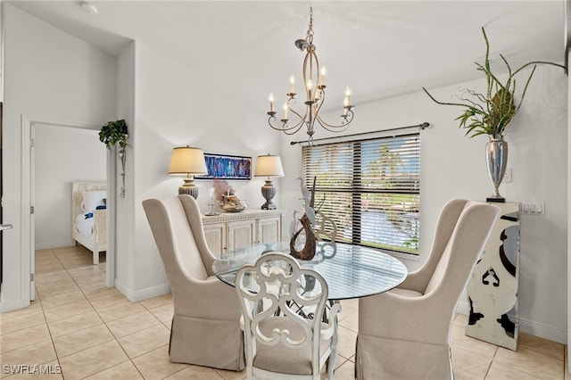 dining space with light tile patterned floors, baseboards, and a notable chandelier