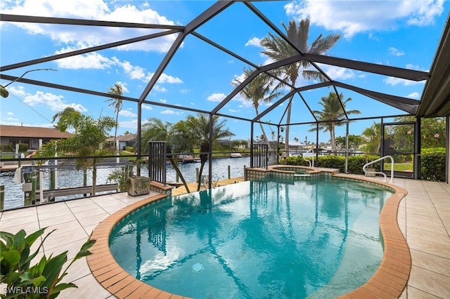 view of swimming pool with a patio area, glass enclosure, a water view, and a pool with connected hot tub