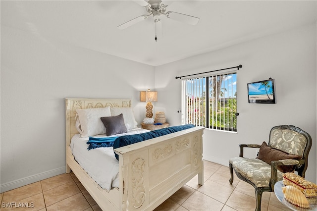 bedroom featuring baseboards, a ceiling fan, and light tile patterned flooring