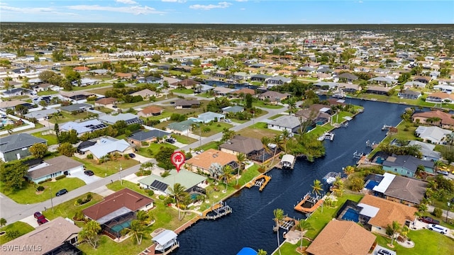 birds eye view of property featuring a water view and a residential view