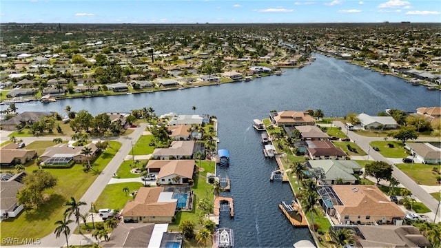 drone / aerial view featuring a water view and a residential view