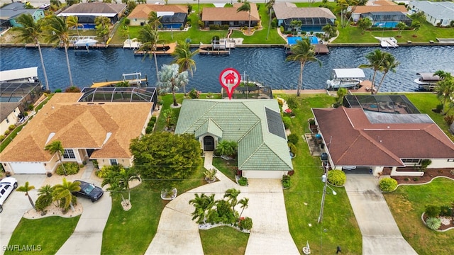 birds eye view of property with a residential view and a water view