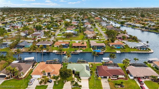 drone / aerial view featuring a water view and a residential view