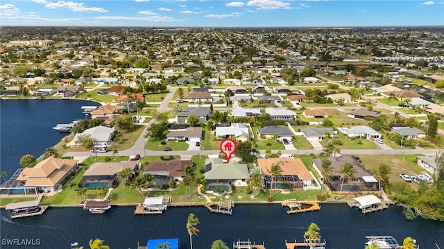 birds eye view of property with a water view and a residential view