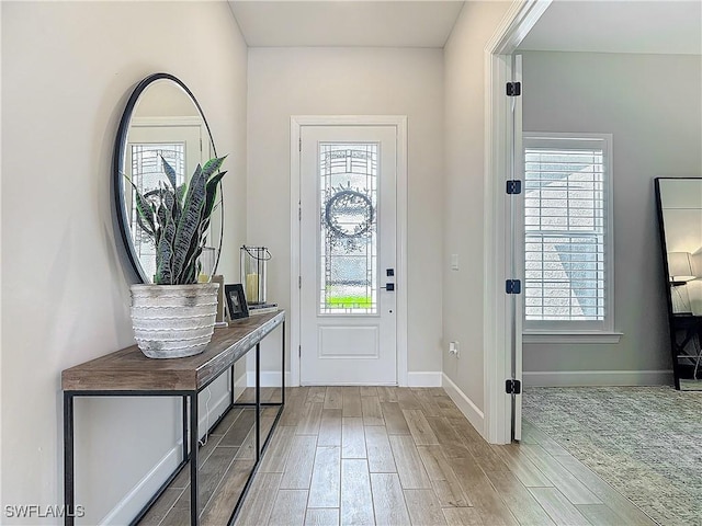 7041 Del Webb Oak Creek Blvd, North Fort Myers, FL 33917 - entrance foyer with baseboards and wood finish floors