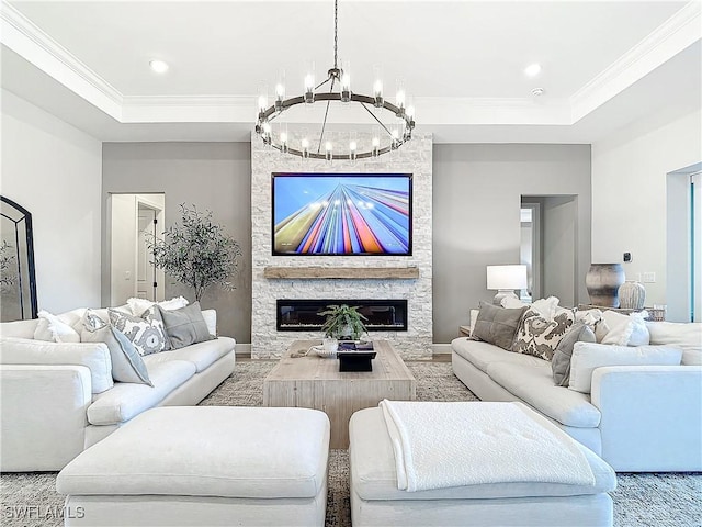 7041 Del Webb Oak Creek Blvd, North Fort Myers, FL 33917 - living area featuring a stone fireplace, ornamental molding, a raised ceiling, and recessed lighting