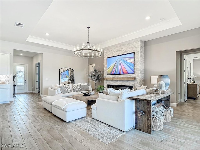 7041 Del Webb Oak Creek Blvd, North Fort Myers, FL 33917 - living area featuring a raised ceiling, visible vents, a fireplace, and light wood finished floors