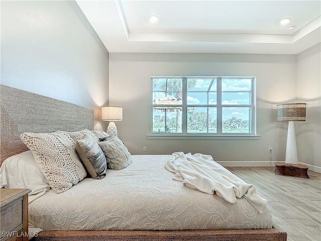 7041 Del Webb Oak Creek Blvd, North Fort Myers, FL 33917 - bedroom with recessed lighting, a raised ceiling, baseboards, and wood finished floors