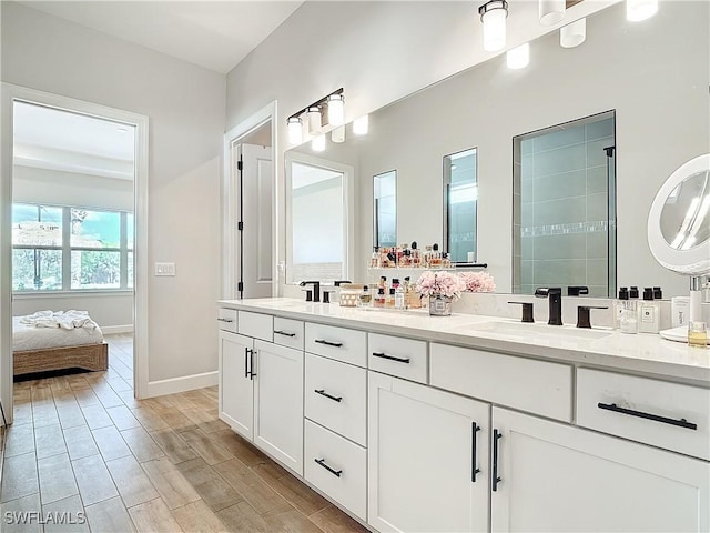 7041 Del Webb Oak Creek Blvd, North Fort Myers, FL 33917 - full bath with double vanity, baseboards, a sink, and wood finished floors