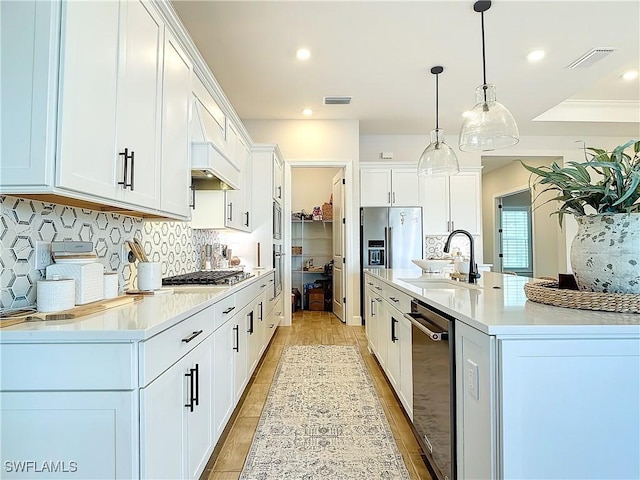 7041 Del Webb Oak Creek Blvd, North Fort Myers, FL 33917 - kitchen featuring light countertops, visible vents, appliances with stainless steel finishes, white cabinetry, and a sink