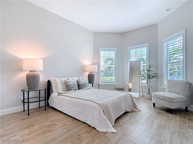 7041 Del Webb Oak Creek Blvd, North Fort Myers, FL 33917 - bedroom with wood tiled floor, multiple windows, and baseboards