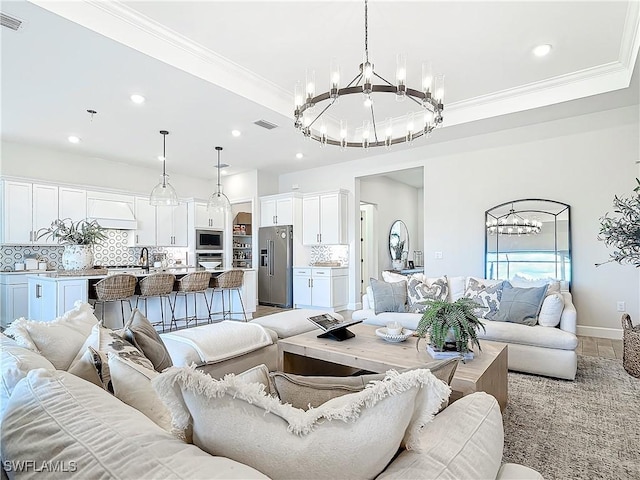 7041 Del Webb Oak Creek Blvd, North Fort Myers, FL 33917 - living room with visible vents, a chandelier, crown molding, and a raised ceiling
