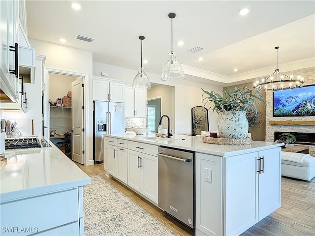 7041 Del Webb Oak Creek Blvd, North Fort Myers, FL 33917 - kitchen featuring a sink, visible vents, white cabinets, appliances with stainless steel finishes, and light wood finished floors