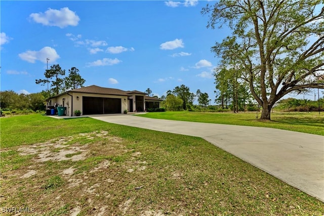 exterior space featuring a garage, concrete driveway, a front lawn, and stucco siding