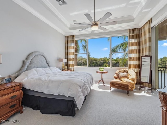 carpeted bedroom with a ceiling fan, visible vents, a tray ceiling, access to exterior, and crown molding