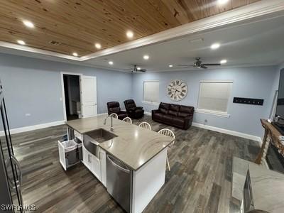 kitchen with ceiling fan, recessed lighting, wood ceiling, open floor plan, and a raised ceiling