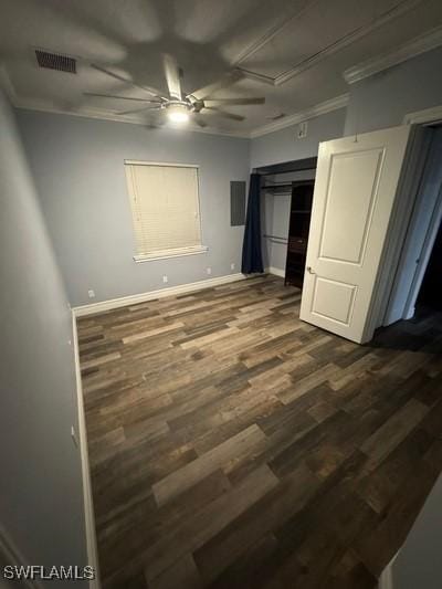 unfurnished bedroom with dark wood finished floors, visible vents, crown molding, and baseboards