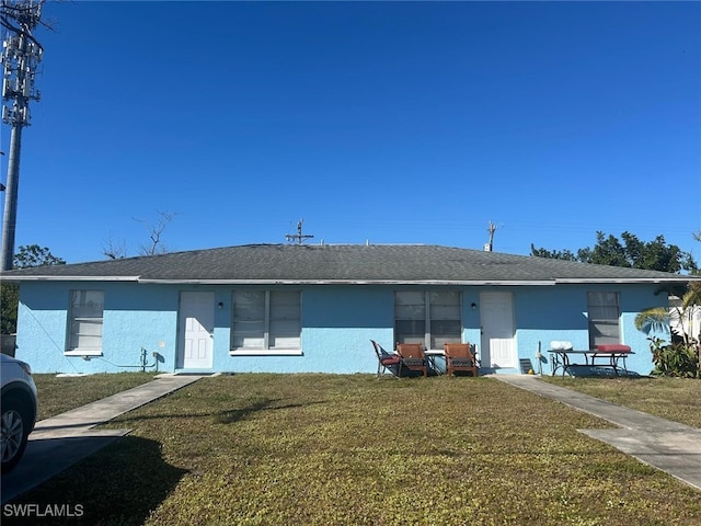 949-949 NE Pine Island Ln Unit 947, Cape Coral, FL 33909 - view of front of property featuring a front lawn and stucco siding