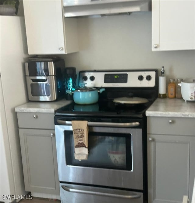 949-949 NE Pine Island Ln Unit 947, Cape Coral, FL 33909 - kitchen with electric range, exhaust hood, gray cabinets, and light countertops