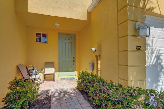 entrance to property featuring stucco siding