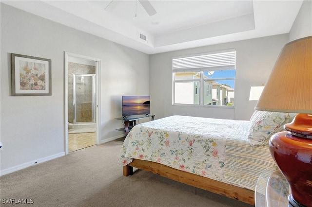 bedroom with a ceiling fan, baseboards, visible vents, a tray ceiling, and carpet flooring