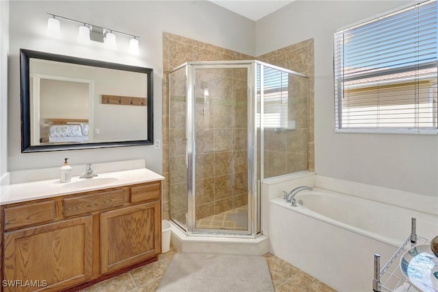 bathroom with vanity, tile patterned floors, a garden tub, and a stall shower