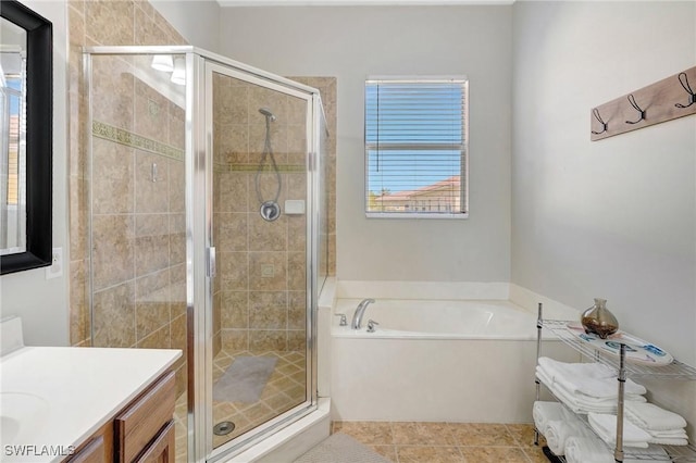 bathroom featuring tile patterned floors, a shower stall, vanity, and a garden tub