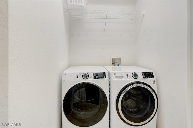 clothes washing area featuring laundry area and independent washer and dryer