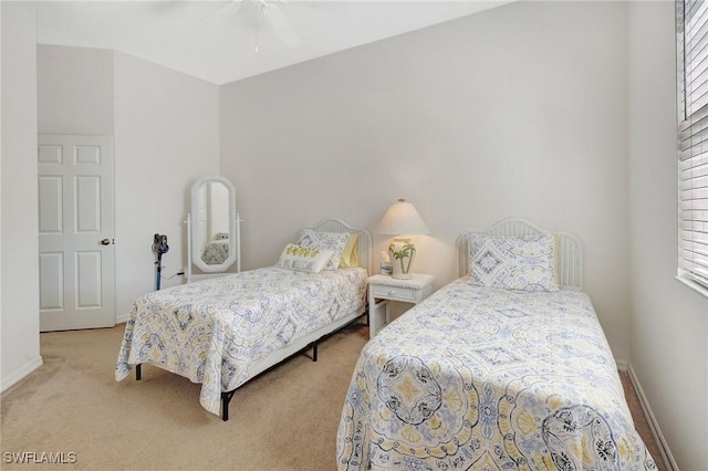 carpeted bedroom with baseboards and ceiling fan