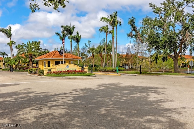 view of street featuring curbs and a gated entry