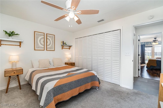 carpeted bedroom featuring baseboards, a closet, and a ceiling fan