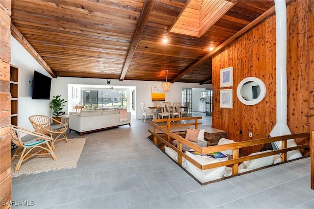tiled living area featuring wood ceiling, plenty of natural light, and wooden walls