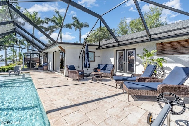 view of patio / terrace featuring a lanai, outdoor lounge area, an outdoor pool, and french doors