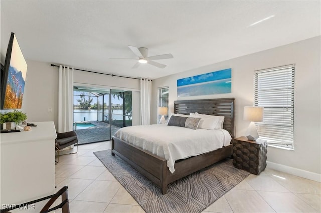 bedroom with light tile patterned floors, a ceiling fan, baseboards, a water view, and access to outside